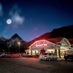 Exterior of the Summit Inn at night with full moon in view